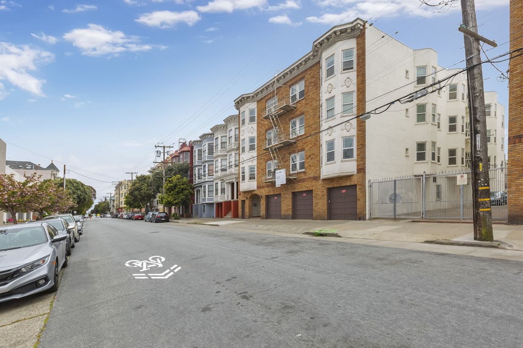 a street view of an apartment building on a city street