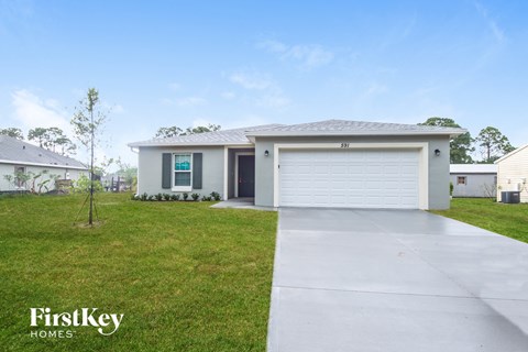 A detached house with a garage is for sale.
