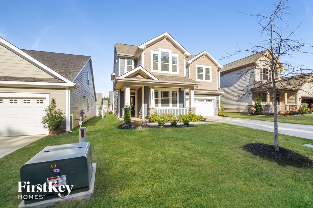 a house with a mailbox on the lawn in front of it
