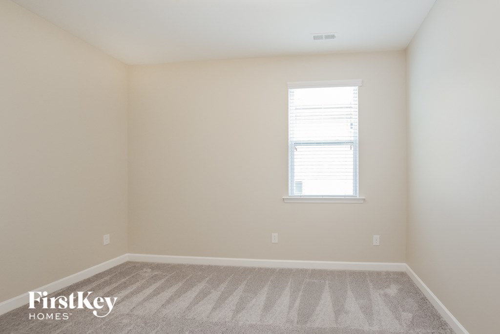 a room with a carpeted floor and a window