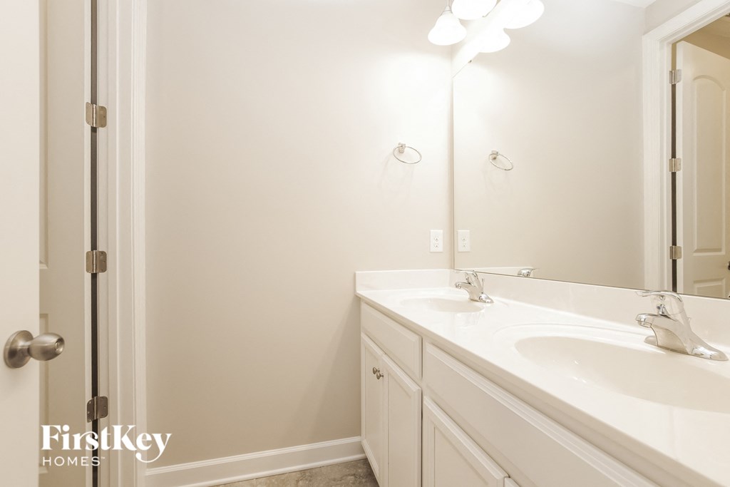 a bathroom with a sink and a mirror and a shower