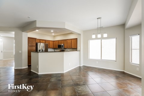 A spacious kitchen with wooden cabinets and a white island.