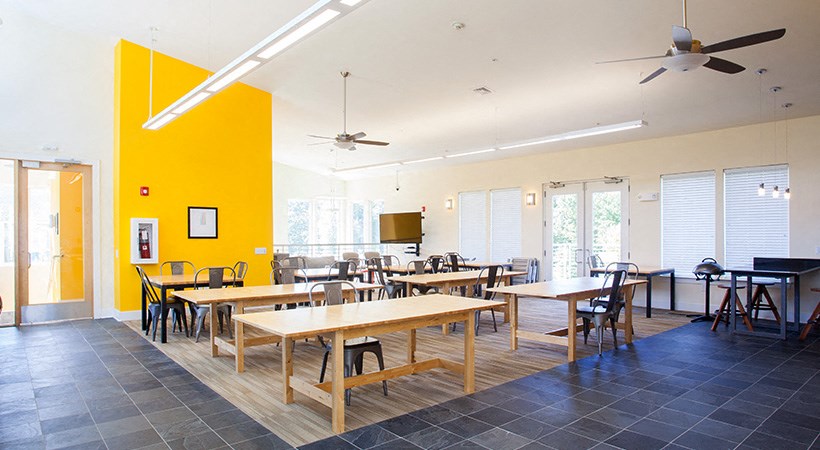 a large dining room with tables and chairs