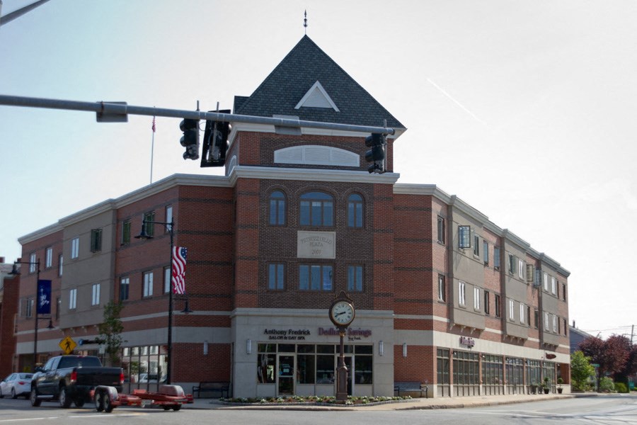 a large brick building with a clock on the front of it