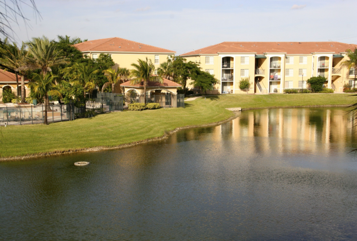 a view of a lake with apartments in the background