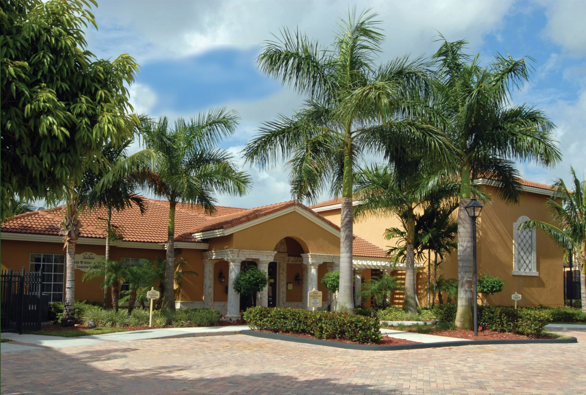 a home with palm trees in front of it