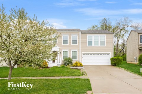 A house with a tree in front of it and the words "FirstKey Homes" on the bottom left.