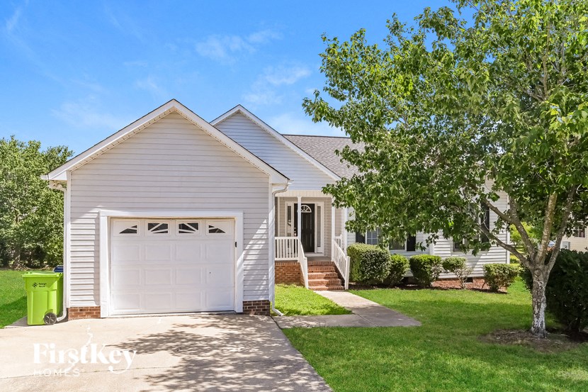 a small white house with a white garage door