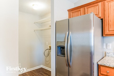 a kitchen with a stainless steel refrigerator and wooden cabinets