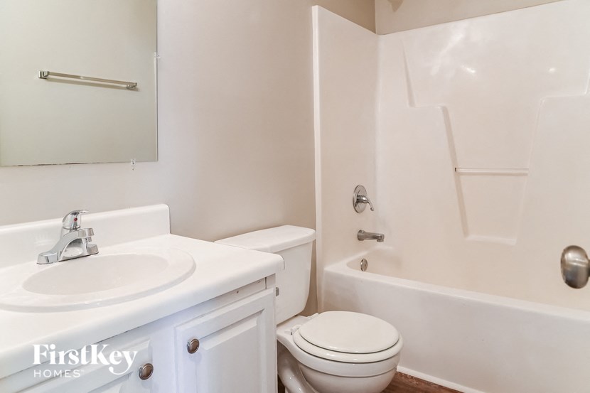 a bathroom with a sink toilet and a tub