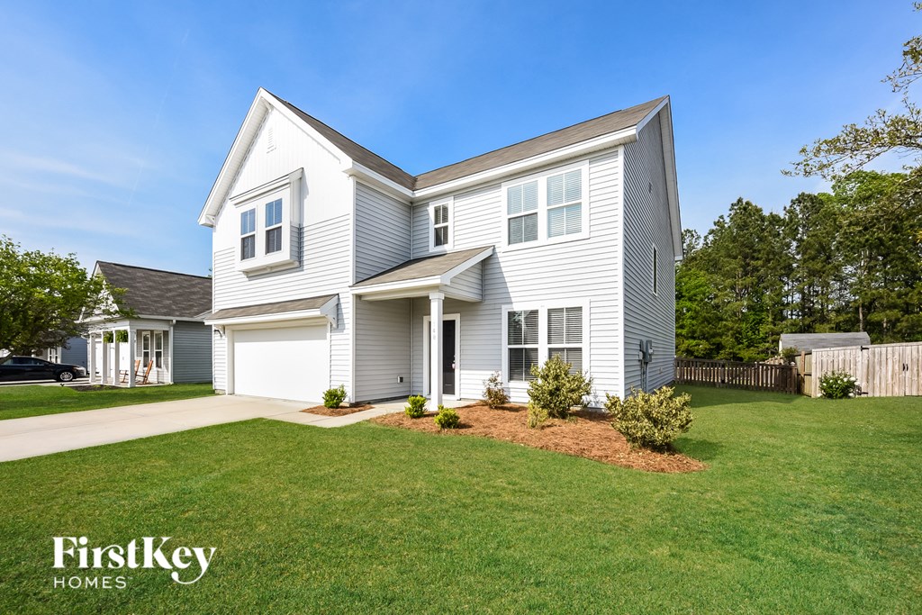 a white house with a lawn in front of it
