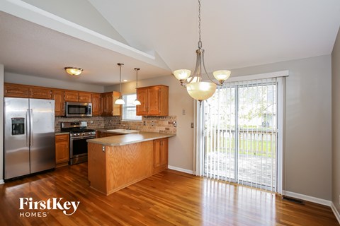 an empty kitchen with a sliding glass door to the patio