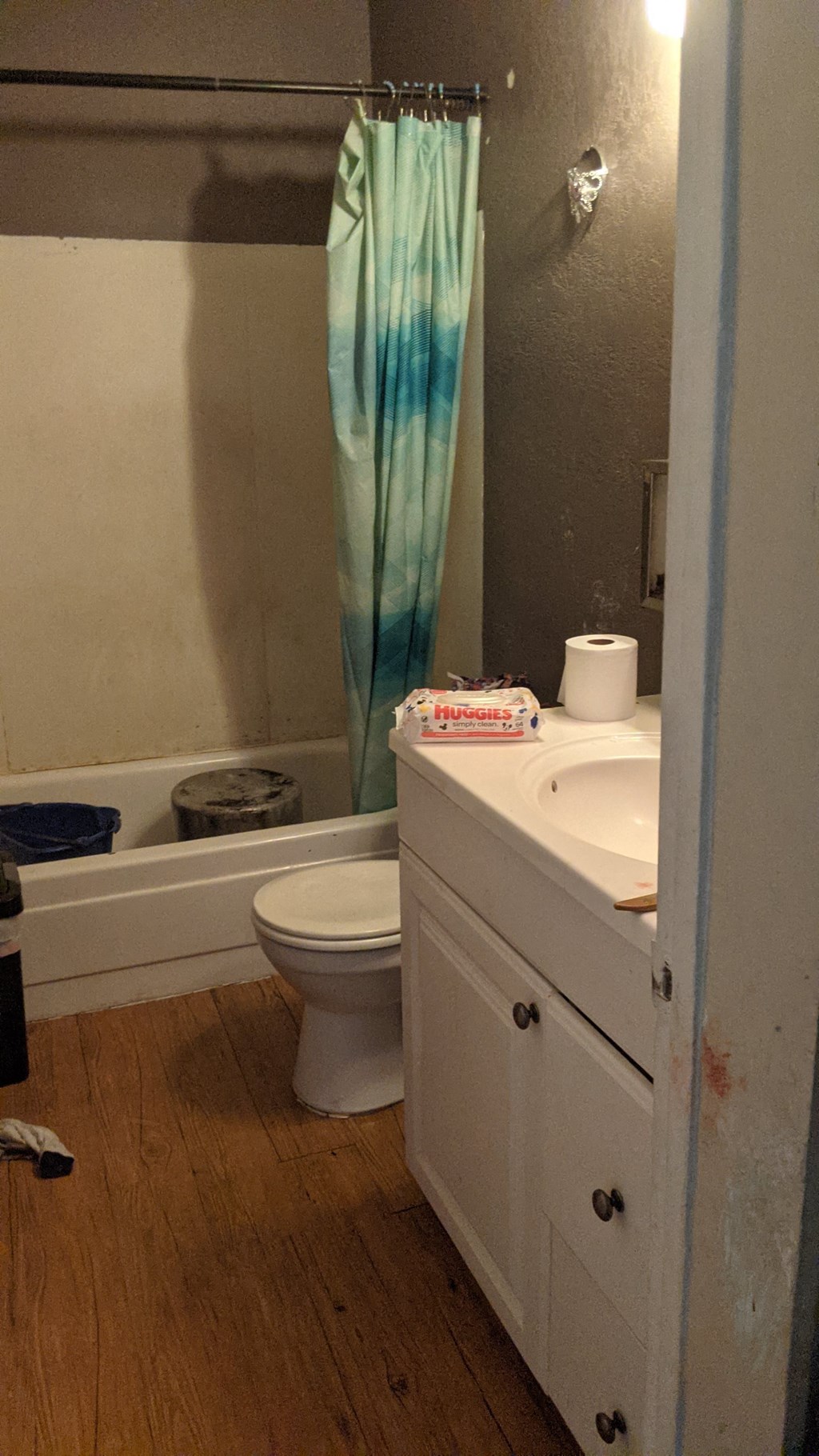 a bathroom with a toilet and a sink and a bath tub