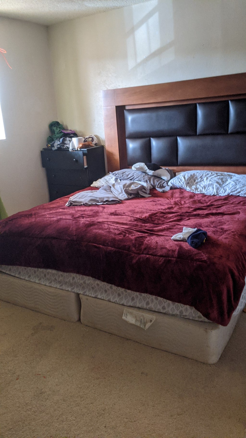 a bed in a bedroom with a red blanket on it