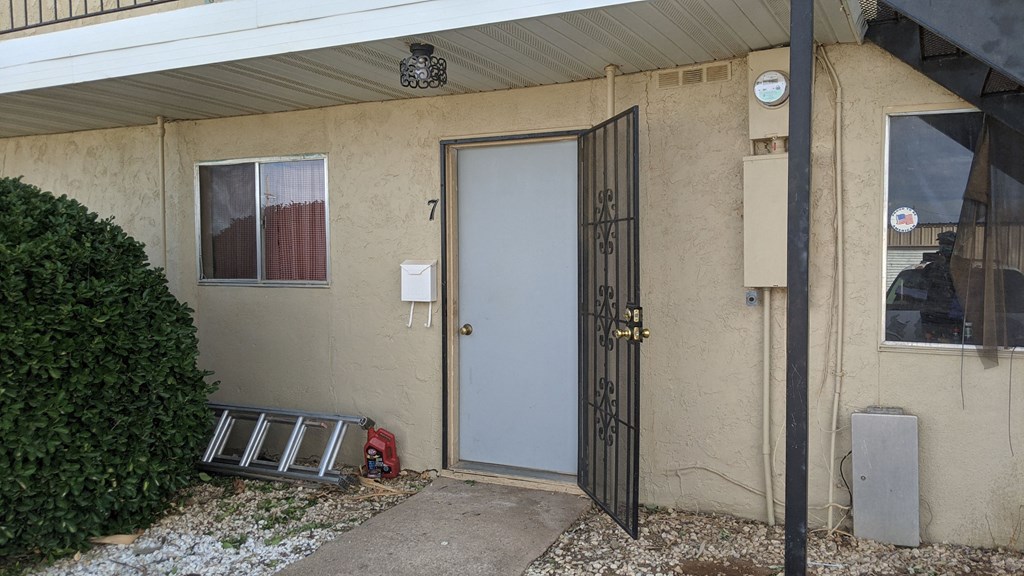 the front door of an apartment building with a white door
