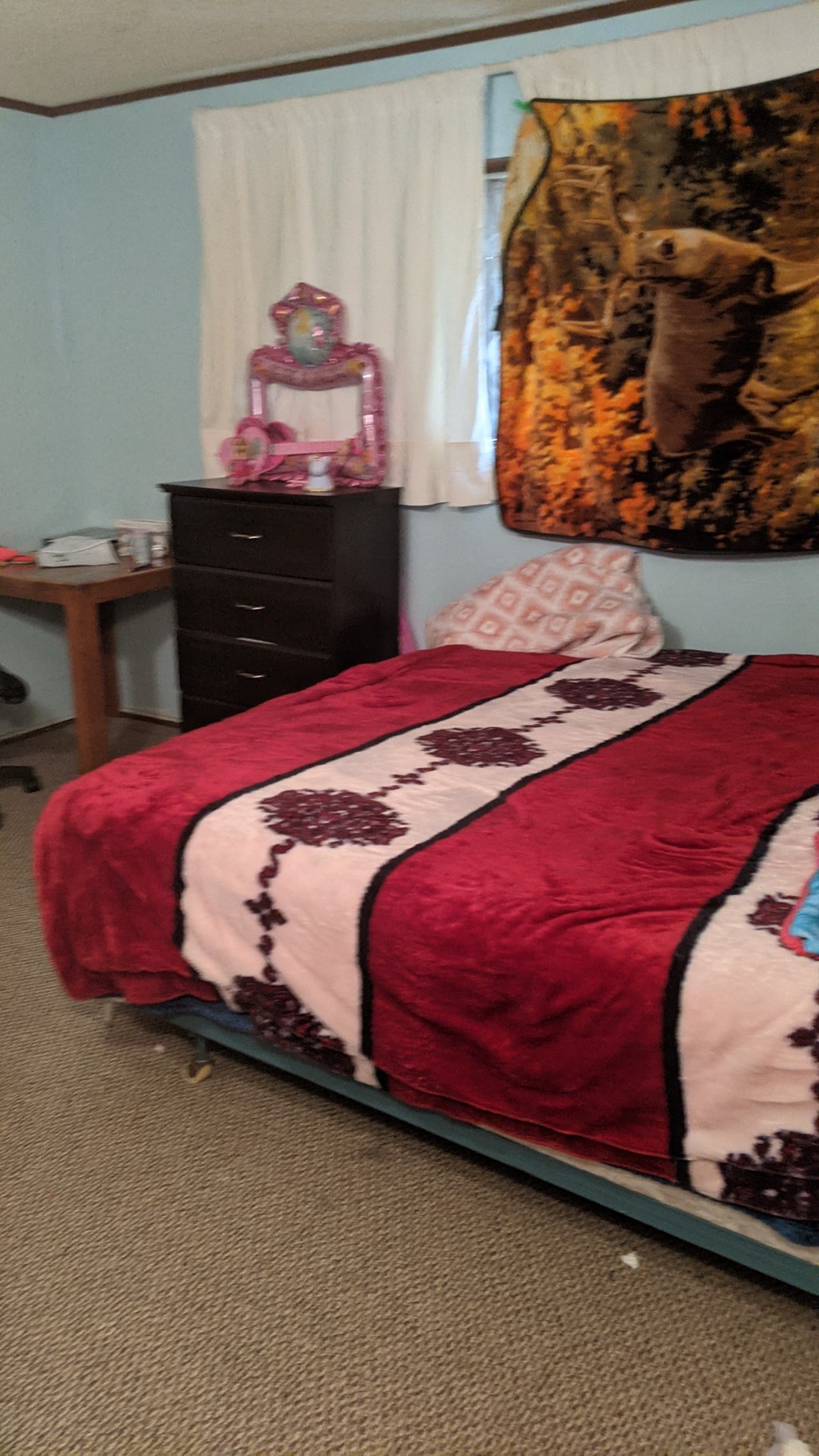 a bedroom with a bed and a dresser in it