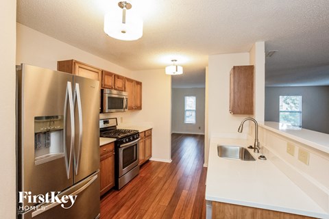 a kitchen with stainless steel appliances and a white counter top