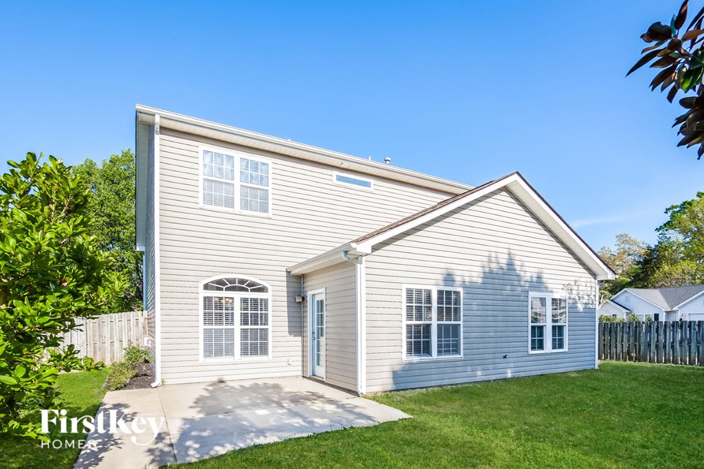 a white house with white siding and a white fence