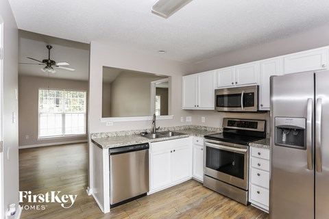 a kitchen with stainless steel appliances and white cabinets