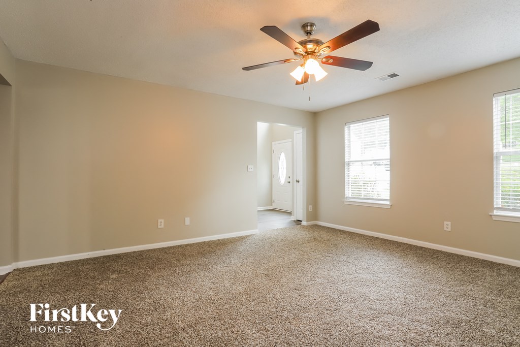 the master bedroom is spacious and has a ceiling fan