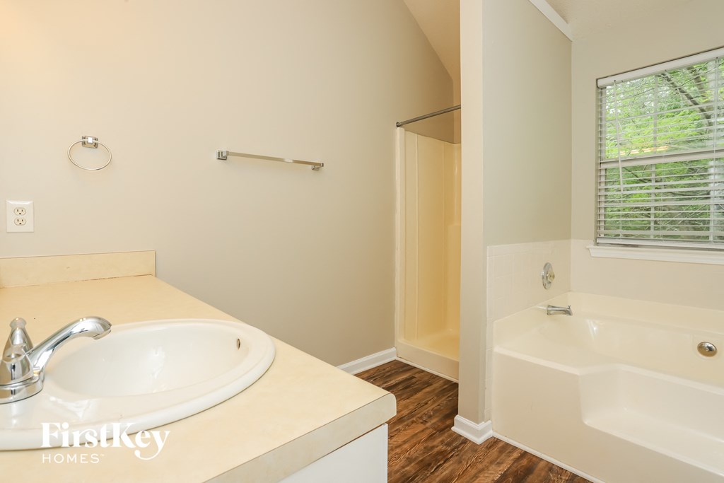 a bathroom with a sink and a tub and a shower