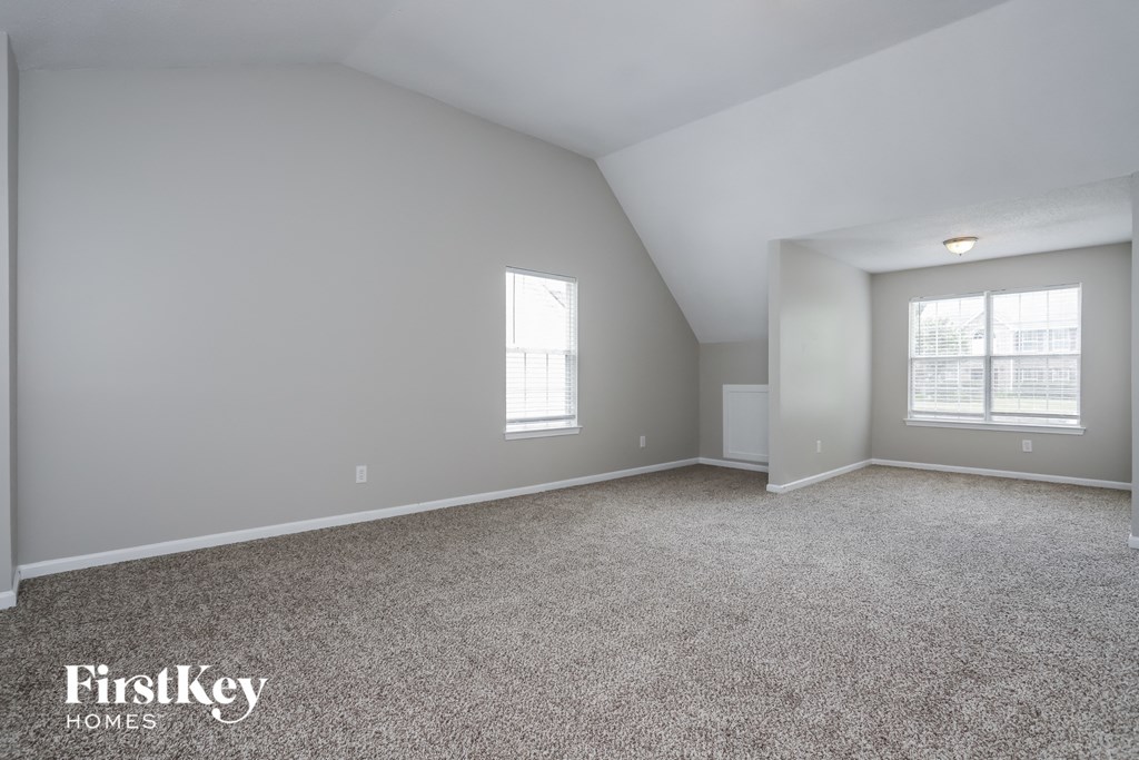 a bedroom with a carpeted floor and a window