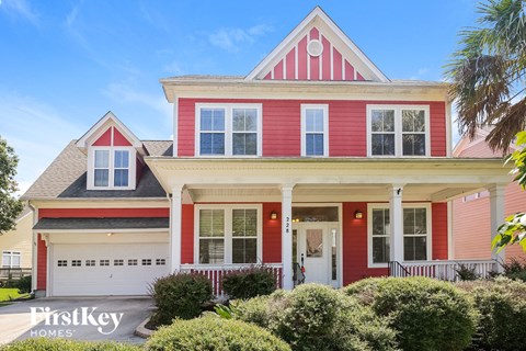 a red house with white trim and a black roof