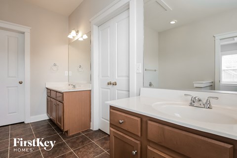a bathroom with a sink and a tub and a mirror