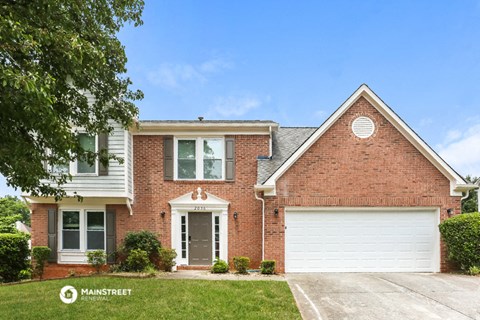 a red brick house with a white garage door