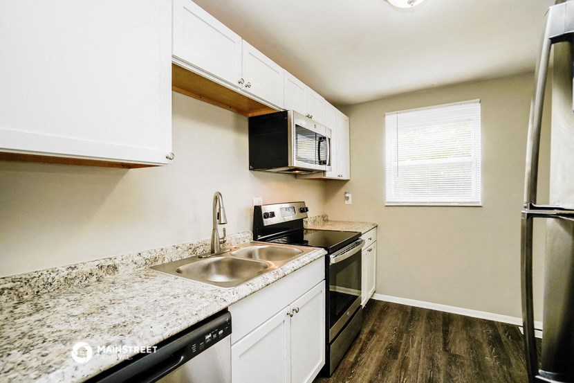 a kitchen with granite counter tops and a sink