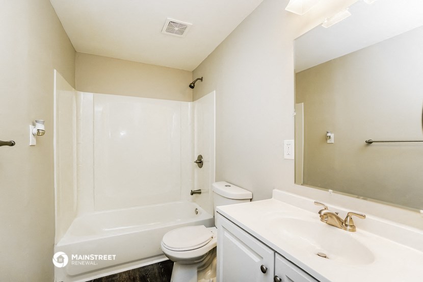 a bathroom with a sink toilet and a tub