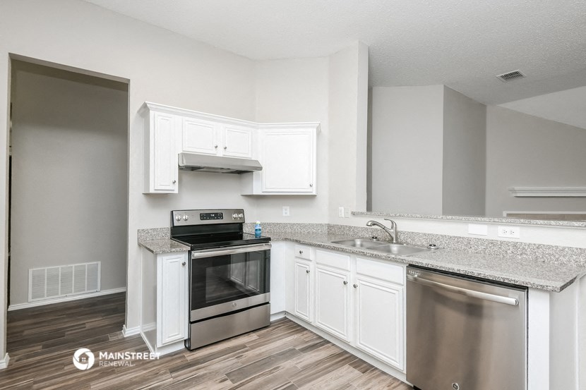the kitchen of our studio apartment atrium with stainless steel appliances and white cabinets