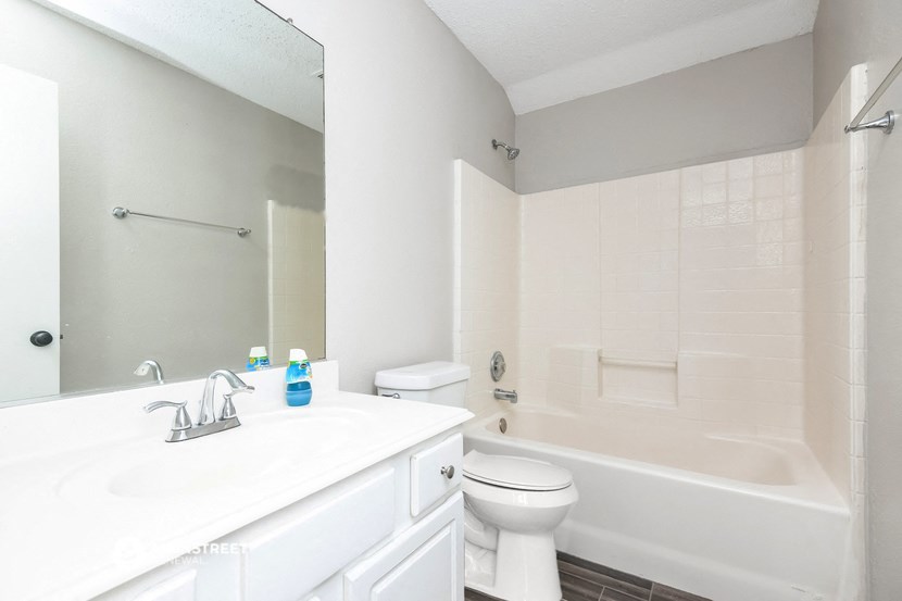 a bathroom with a sink toilet and a bath tub