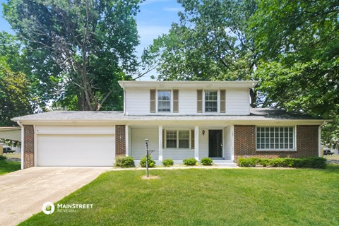 a white house with a lawn in front of it