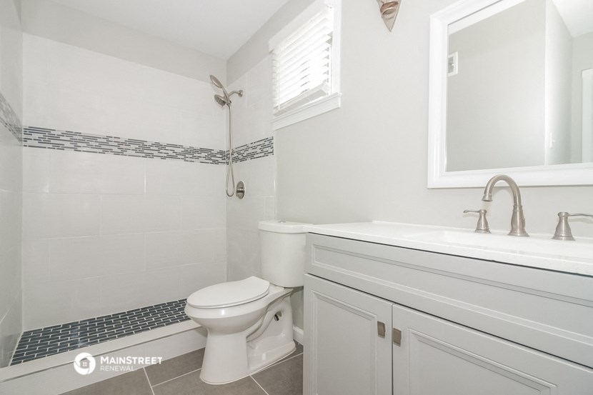 a white bathroom with a toilet and a sink