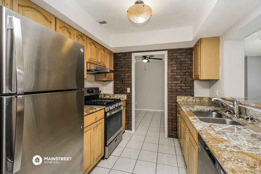 a kitchen with stainless steel appliances and granite counter tops