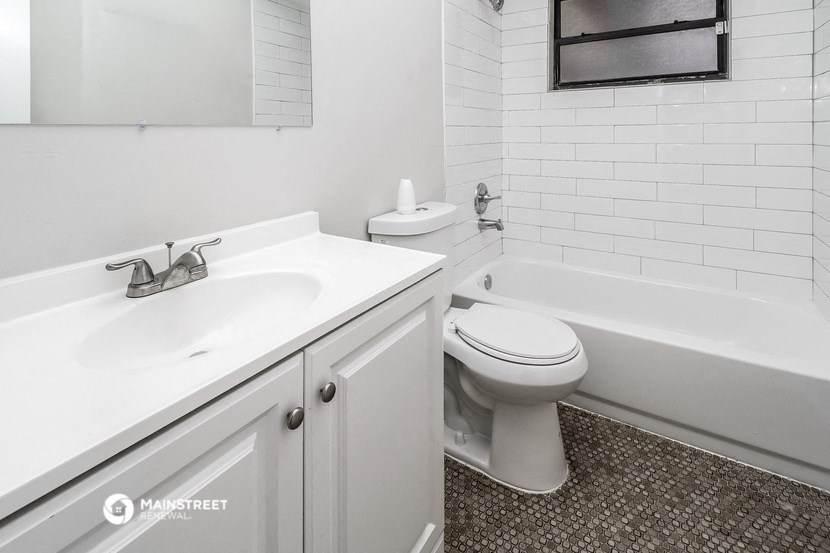 a white bathroom with a sink toilet and bath tub