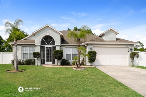 a house with palm trees in front of it