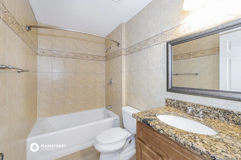 a bathroom with a sink toilet and a bath tub