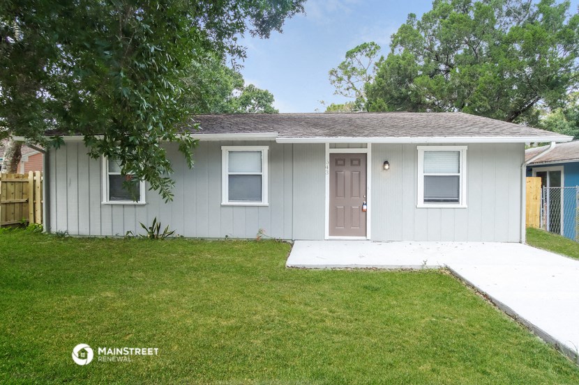 a white house with a yard and a door