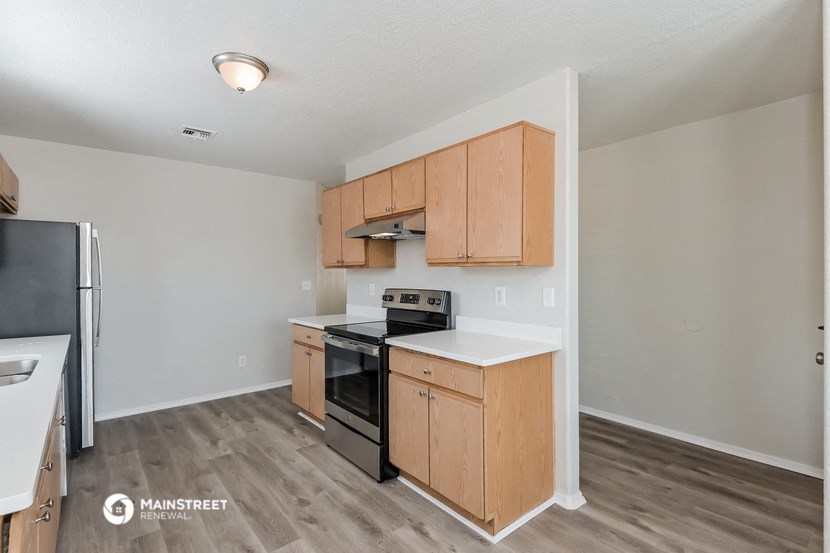 the kitchen of our studio apartment atrium with stainless steel appliances and wooden cabinets