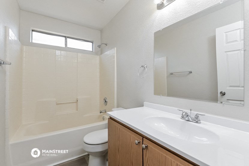 a bathroom with a sink and a toilet and a shower