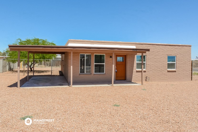 a small brick building with a porch and a door
