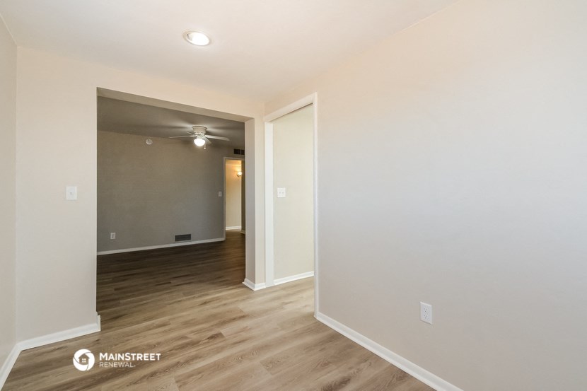 the living room and dining room of an apartment