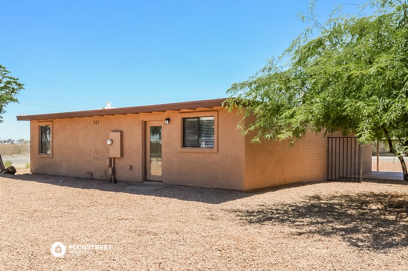 a small house with a tree in front of it