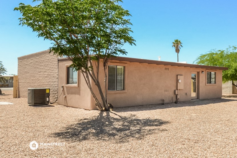 a small house with a tree in front of it