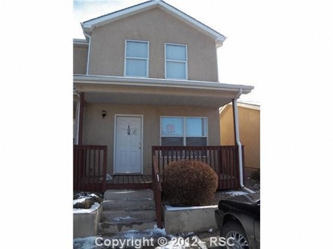 a house with a front porch and a white door