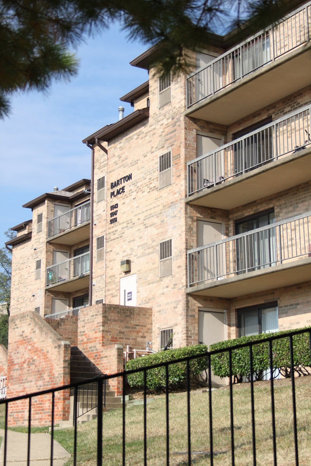 an apartment building with a fence in front of it
