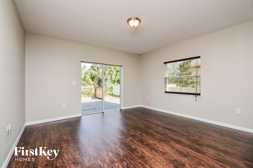 the living room and dining room with hardwood flooring and a sliding glass door