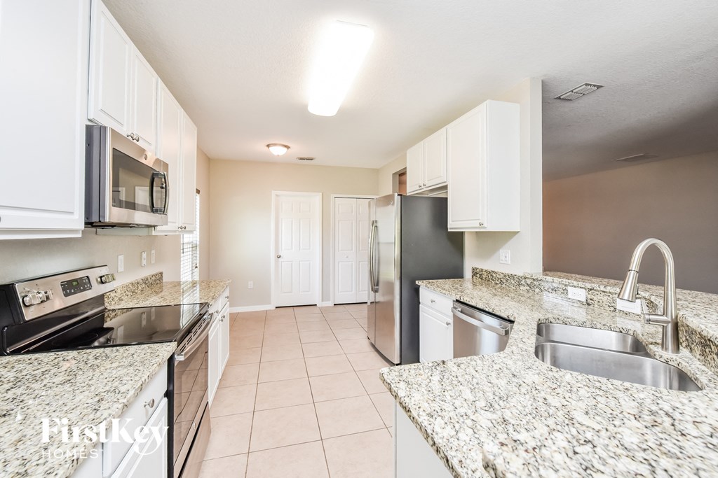 a kitchen with granite counter tops and stainless steel appliances